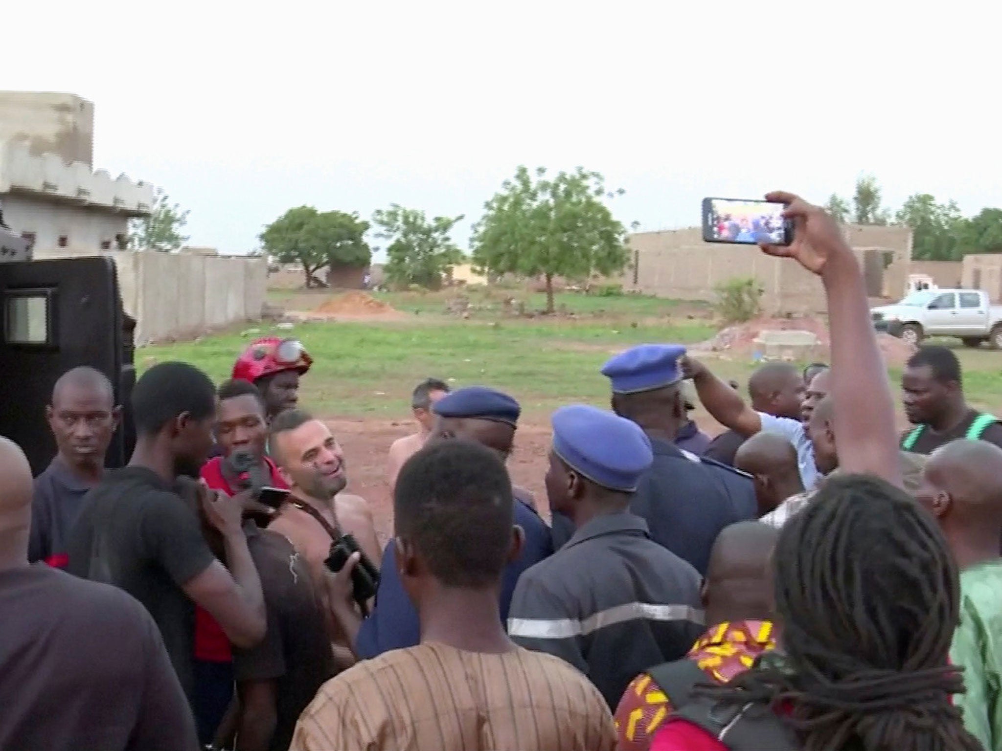 Police with four people rescued from the Le Campement Kangaba resort following an attack where gunmen stormed the resort in Dougourakoro, to the east of the capital Bamako