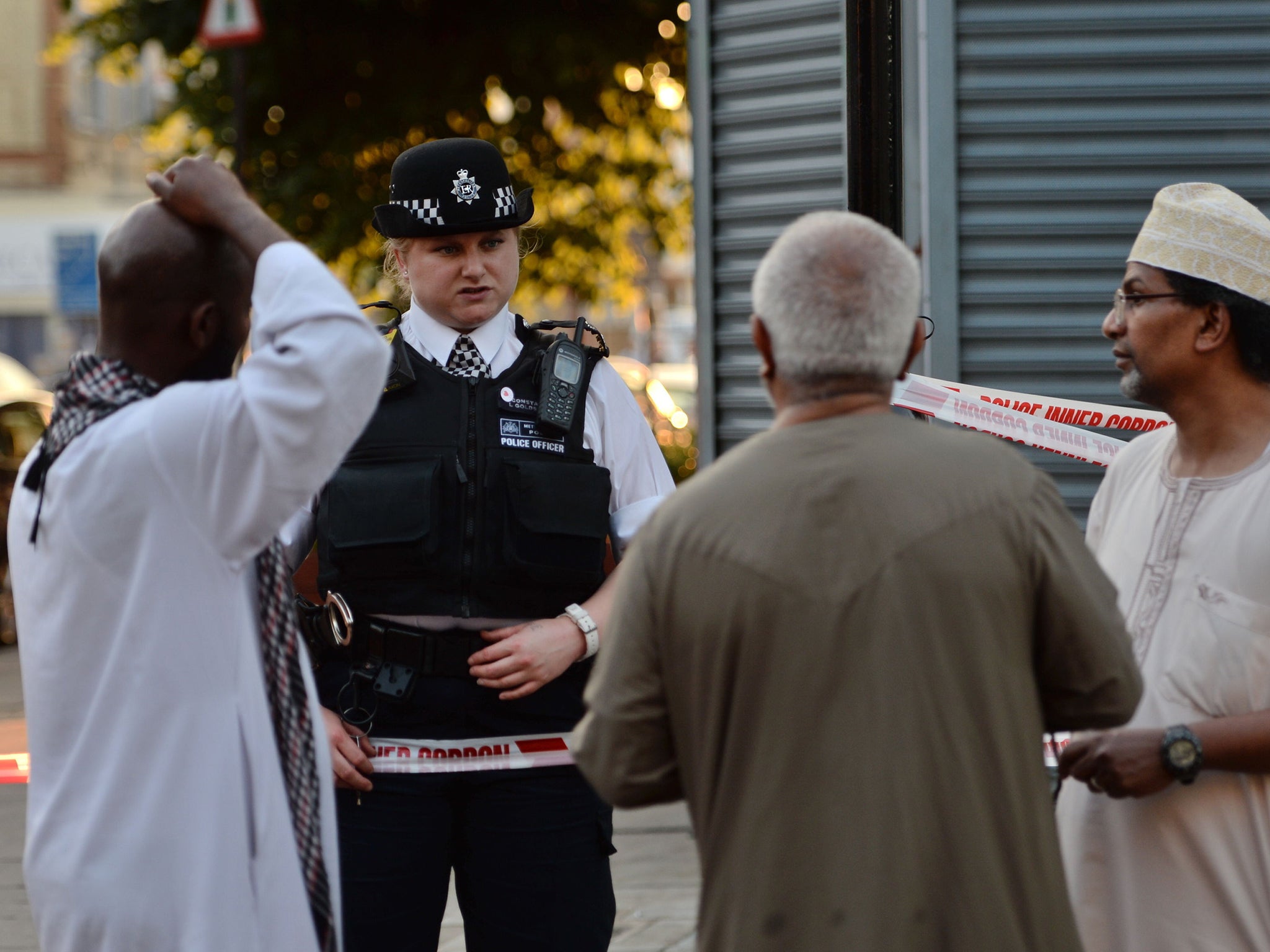 Police talk to local people at Finsbury Park after the attack