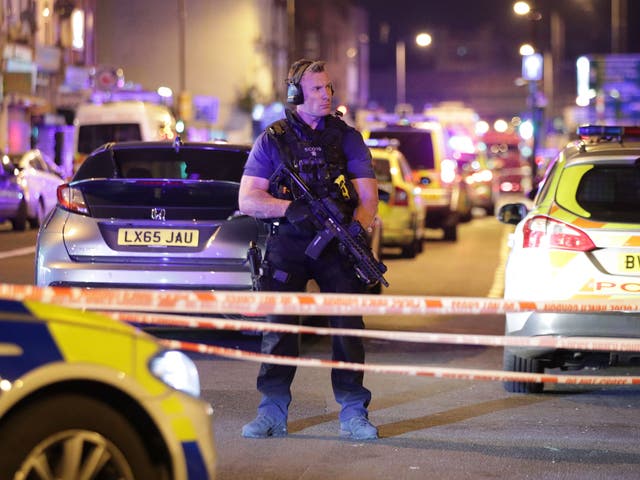An armed police officer mans a cordon on the Seven Sisters Road at Finsbury Park in north London, where one person has been arrested after a vehicle struck pedestrians
