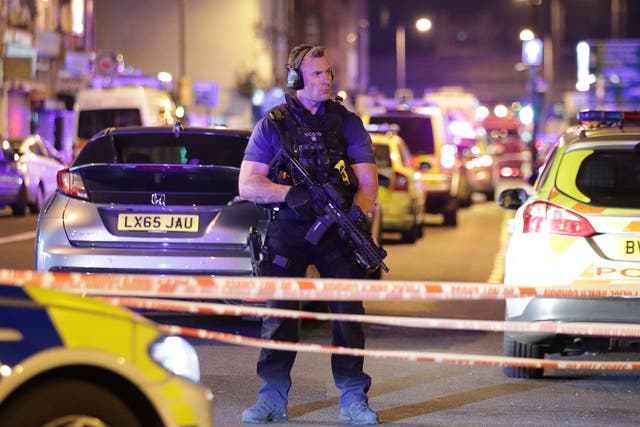 An armed police officer mans a cordon on the Seven Sisters Road at Finsbury Park in north London, where one person has been arrested after a vehicle struck pedestrians