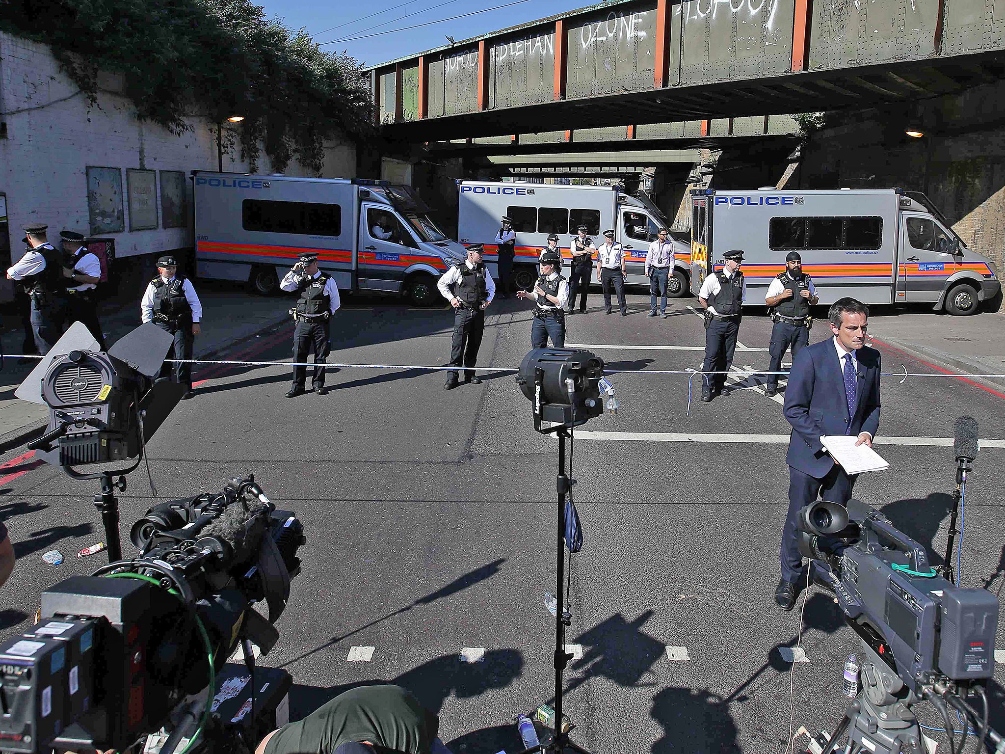 Police officers stand on duty at a cordon near the scene in Finsbury Park (AFP/Getty)