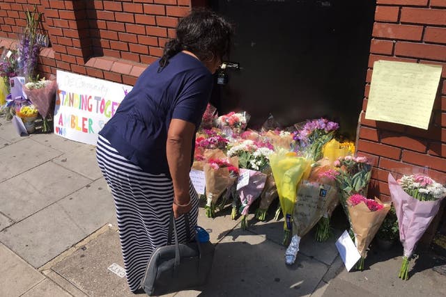 Community members lay flowers after a van ploughed into Muslim worshippers outside a north London mosque