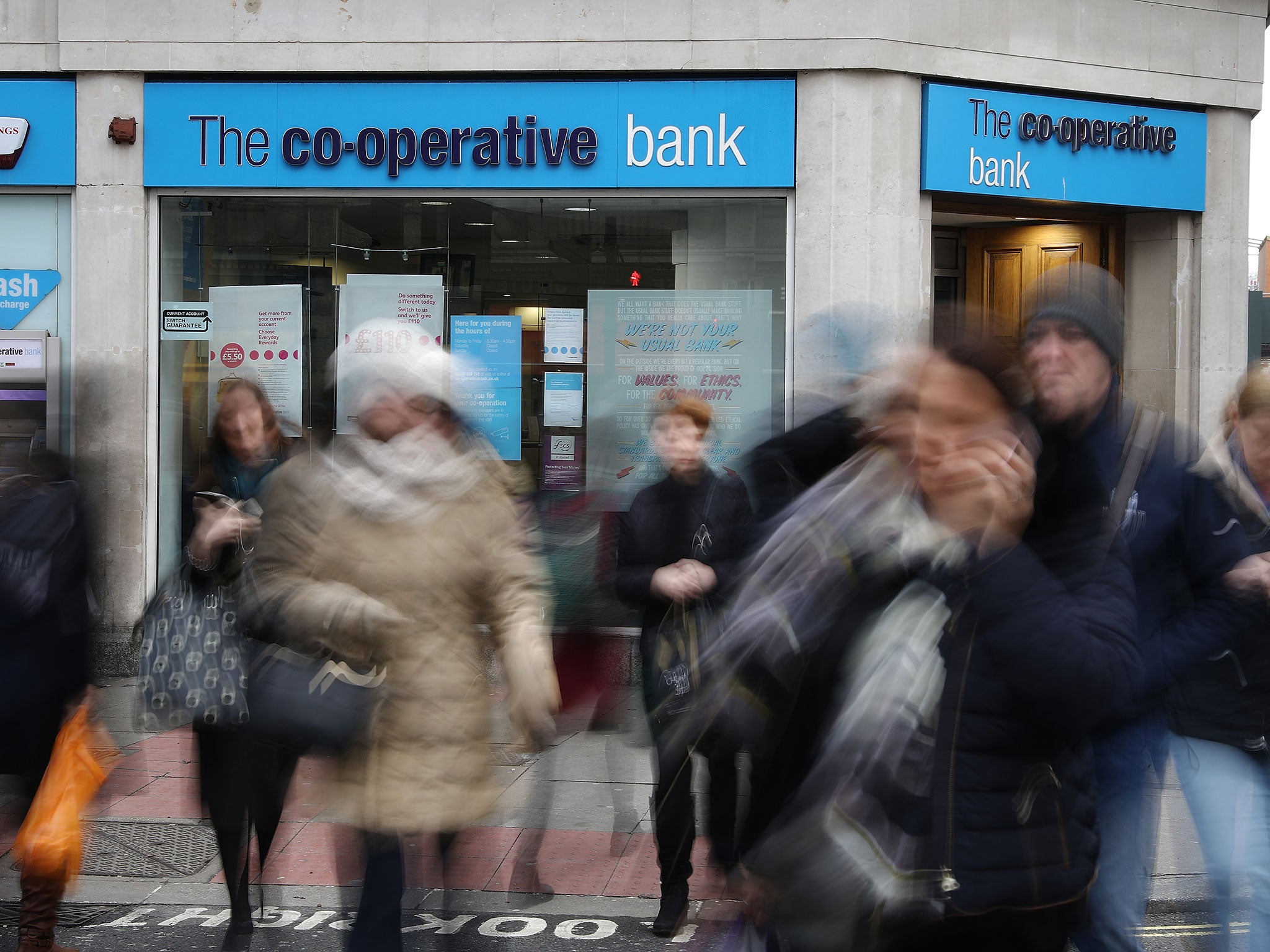 Members of the public walk past the Co-op Bank