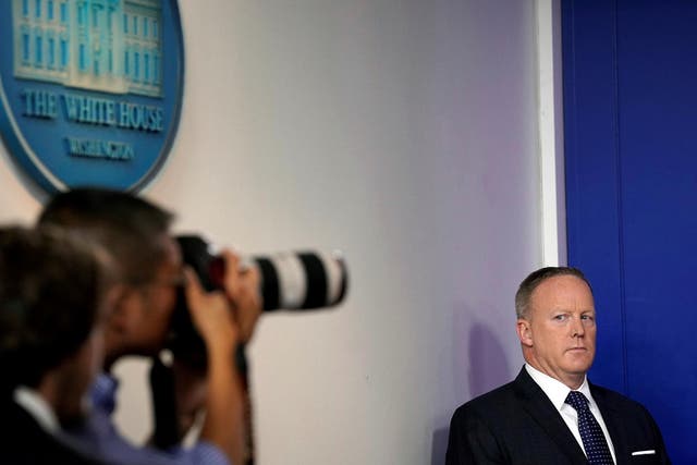 White House Press Secretary Sean Spicer looks at a photographer during the daily briefing