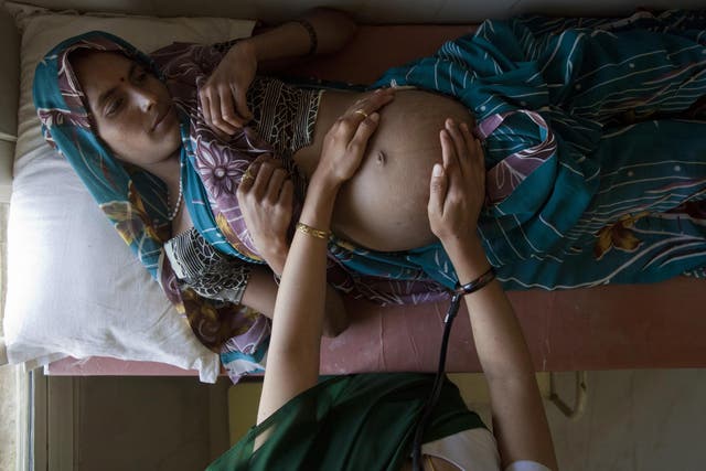 A 25-year-old pregnant woman is examined at a community health centre in the remote village of Chharchh, in the central Indian state of Madhya Pradesh