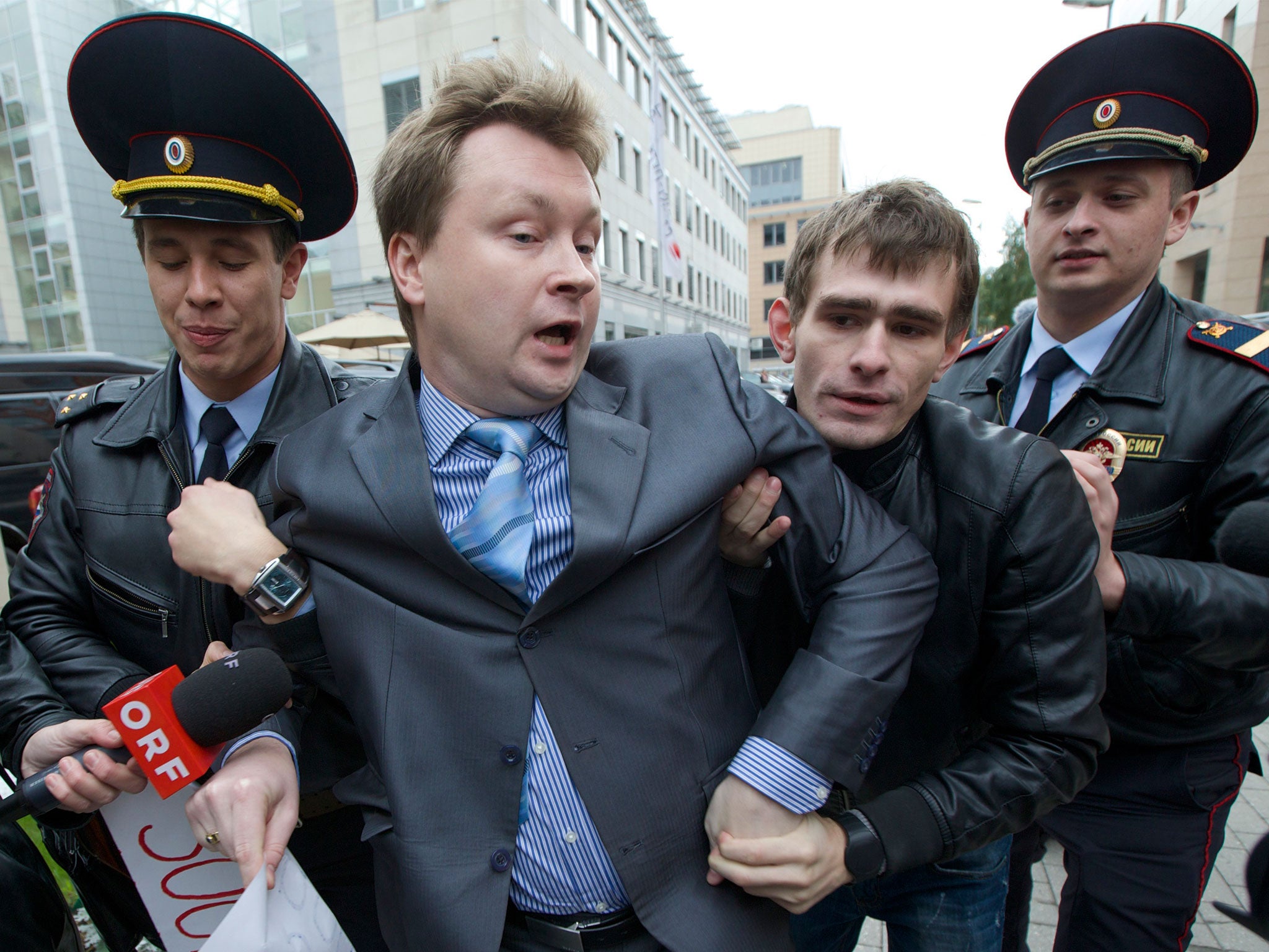 Police detain Nikolai Alexeyev during a protest outside the Sochi 2014 Winter Olympic Games