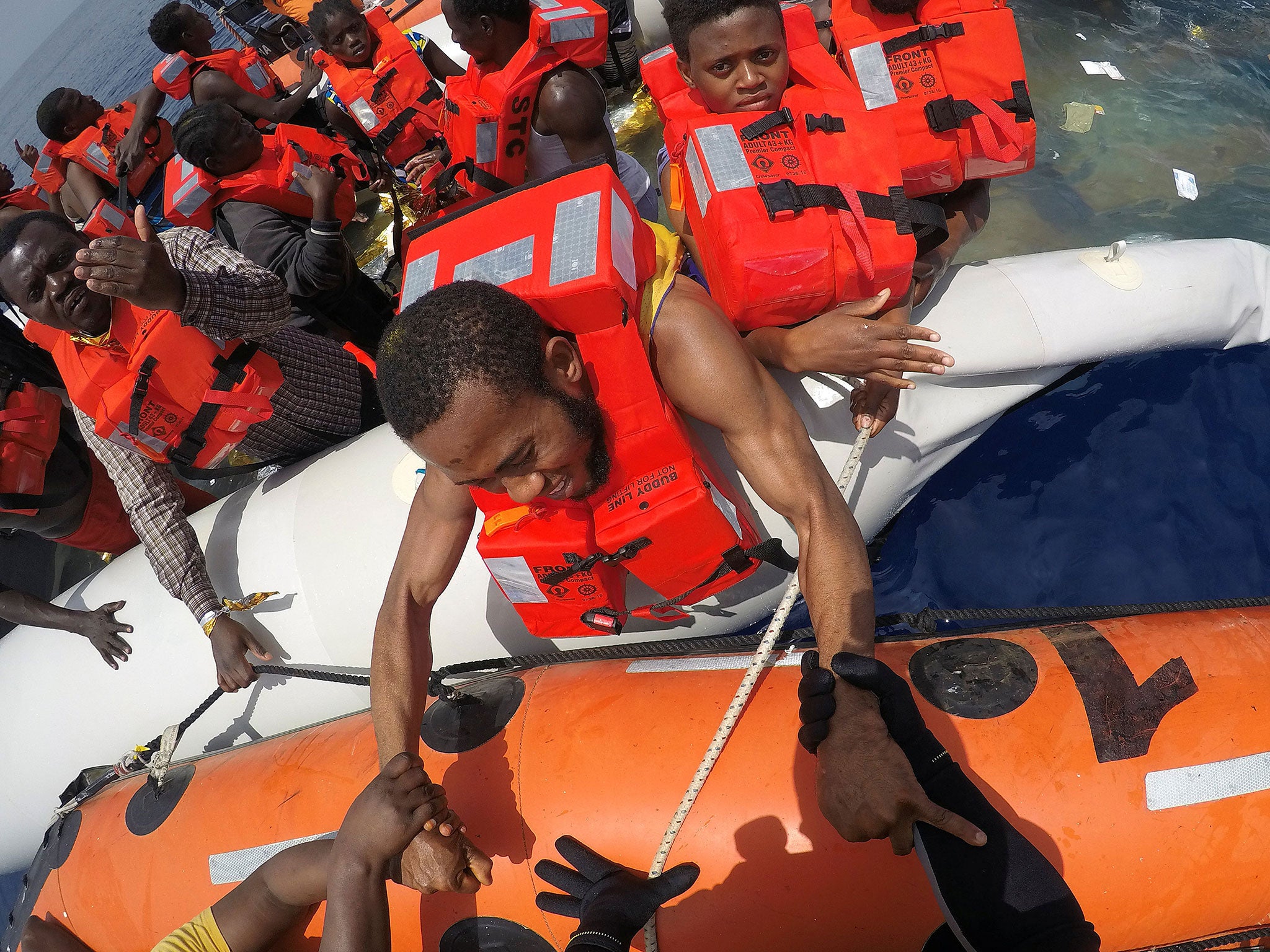 Migrants on a dinghy are rescued by Save the Children NGO crew from the ship ‘Vos Hestia’ off the coast of Libya, 17 June 2017
