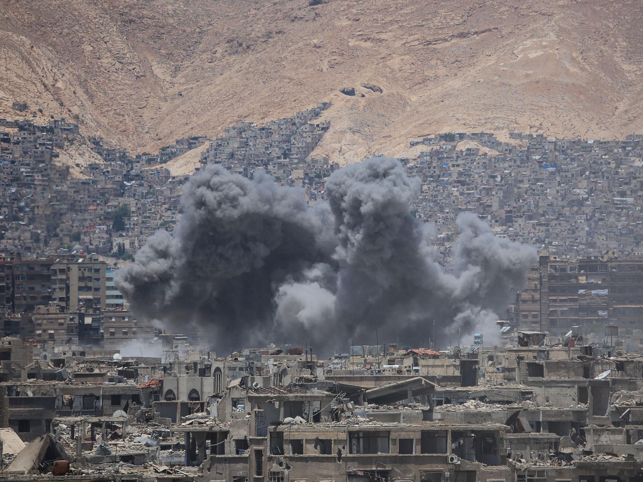 Smoke billows following a reported air strike in the rebel-held parts of the Jobar district, on the eastern outskirts of the Syrian capital Damascus, on 18 June, 2017