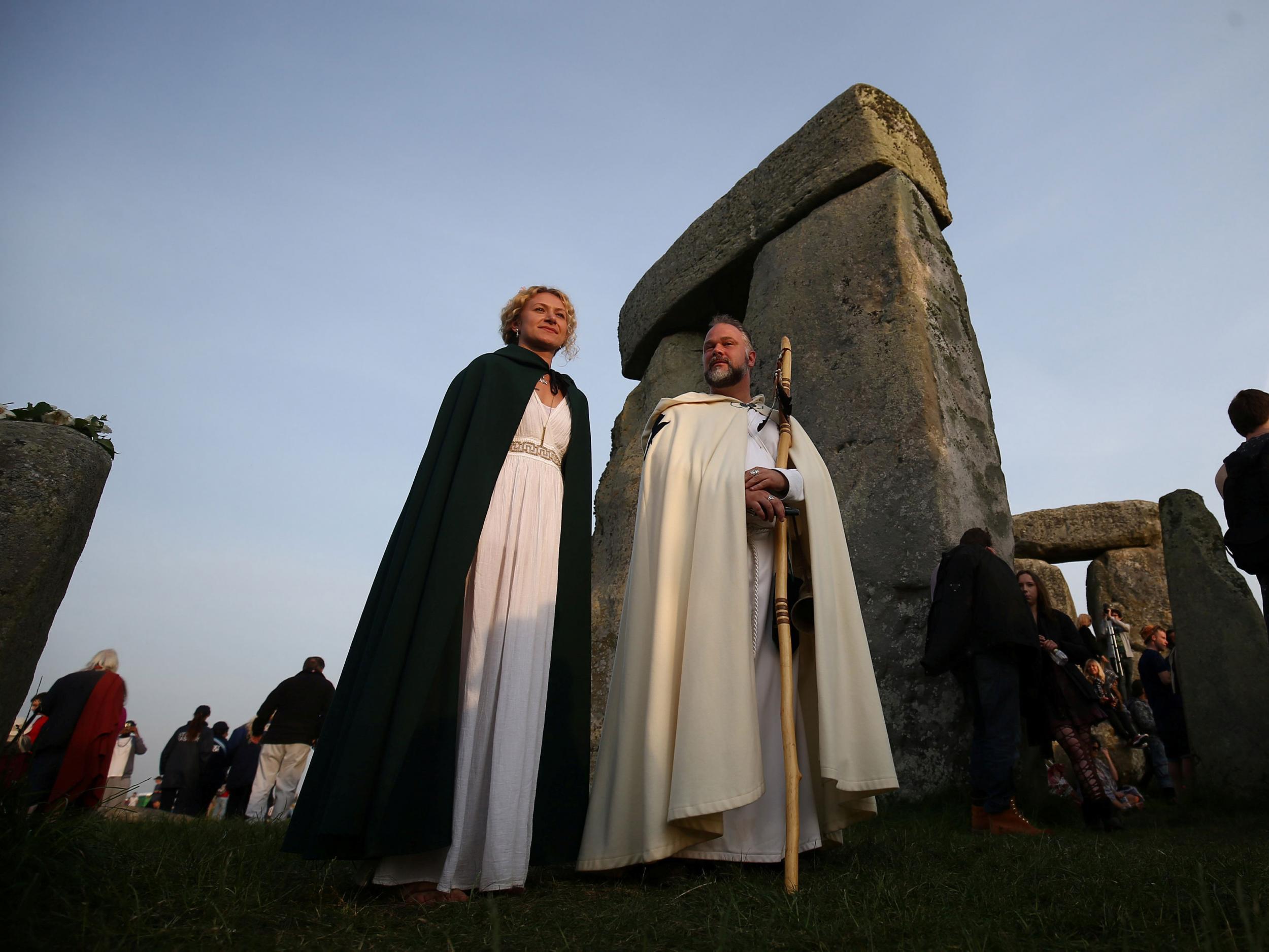 Those clothed in druid costume watch the sun rise on the Stonehenge monument