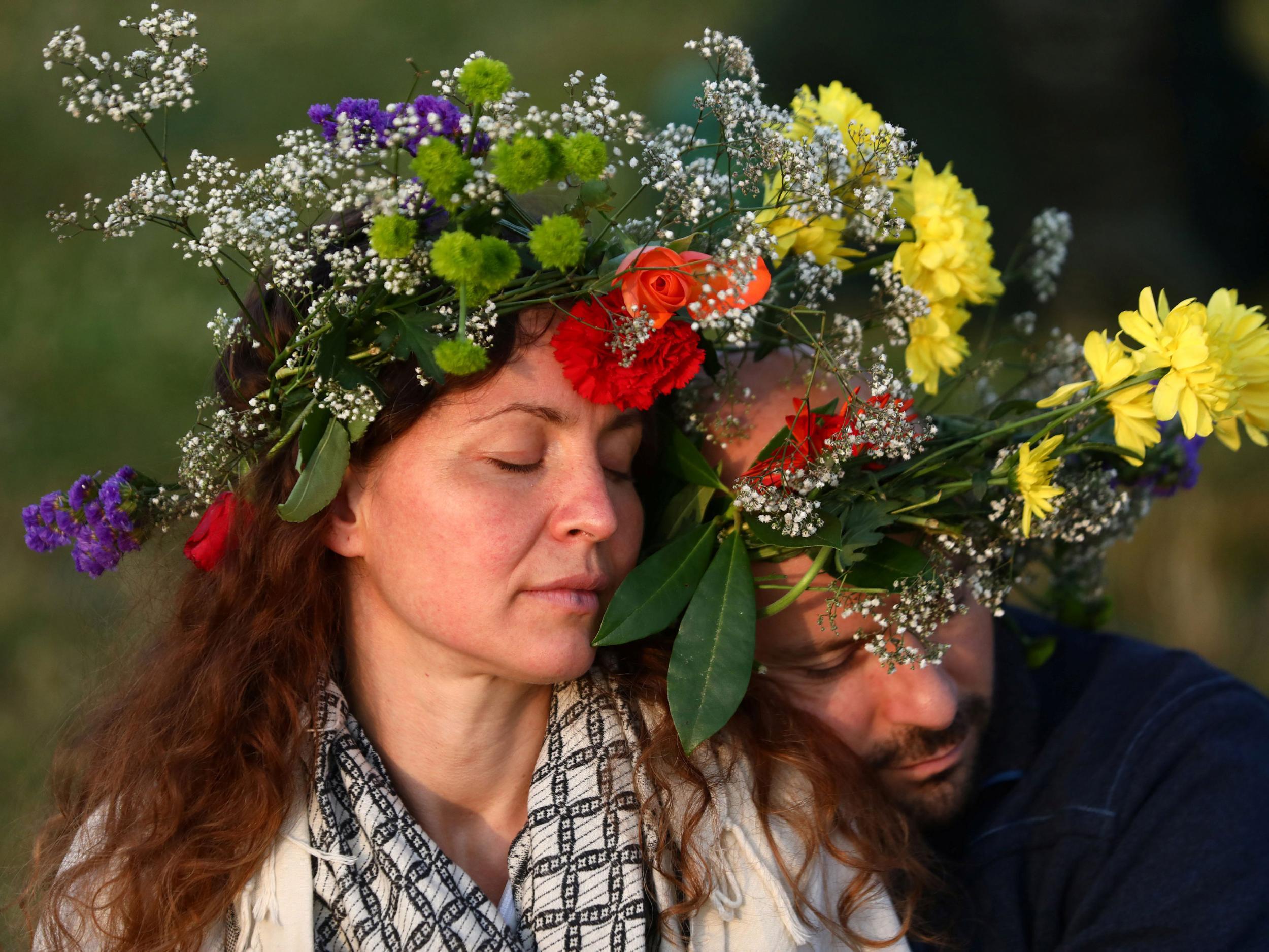 Others wore flower garlands as the sun rose on the late-Neolithic monument