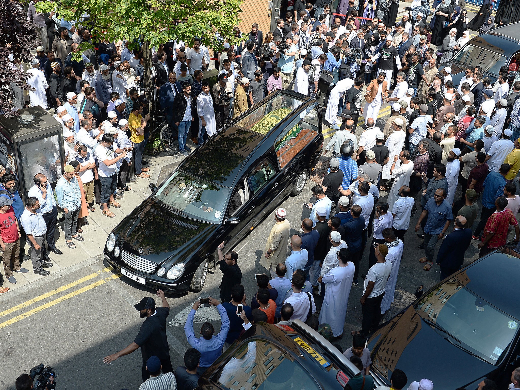 The coffin of Mohammad Alhajali, a victim of the deadly Grenfell Tower blaze, is taken from the east London Mosque in Whitechapel, for his burial.