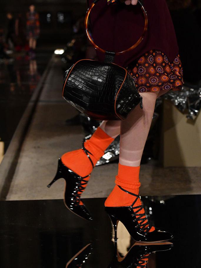 Models at Givenchy wore lace-up sandals with thick socks in red, brown or purple