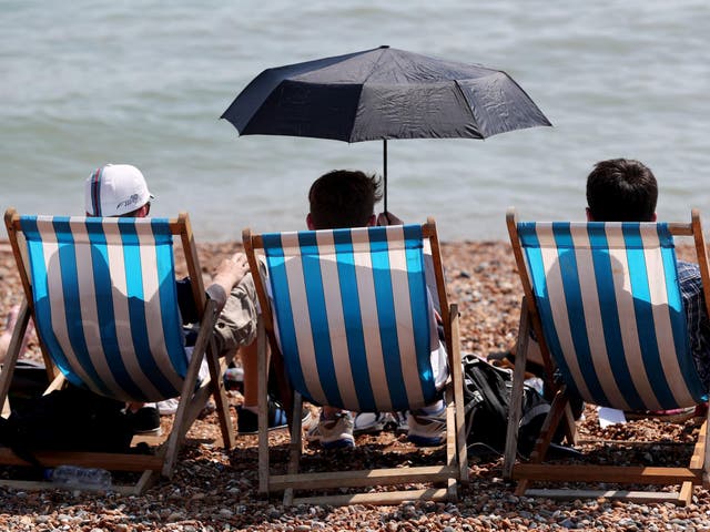 People enjoy the hot weather on the beach in Brighton, East Sussex