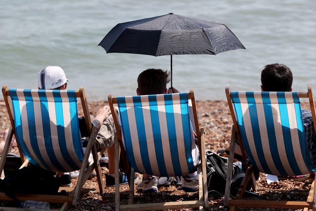 People enjoy the hot weather on the beach in Brighton, East Sussex