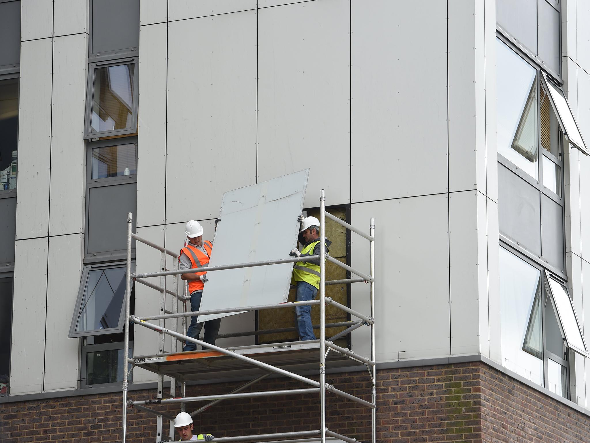 A portion of cladding being removed from a housing block in north London