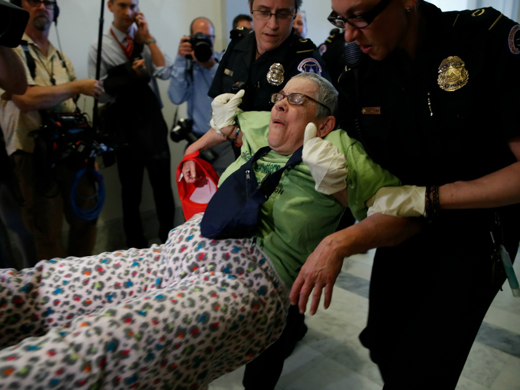 In some instances, police helped protesters back into their wheelchairs before forcibly removing them, but others weren't treated so generously