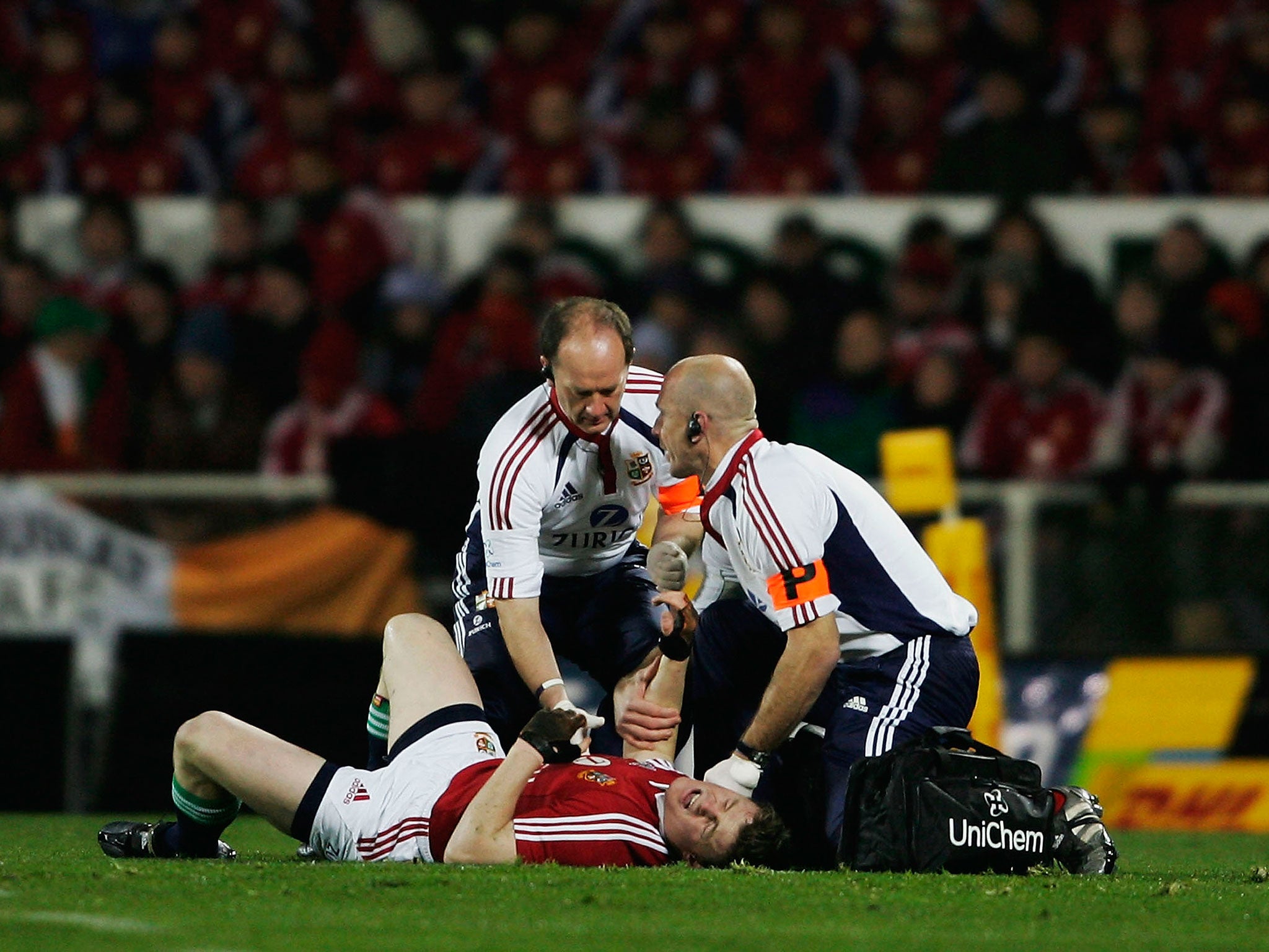 Brian O’Driscoll receives treatment following the spear tackle