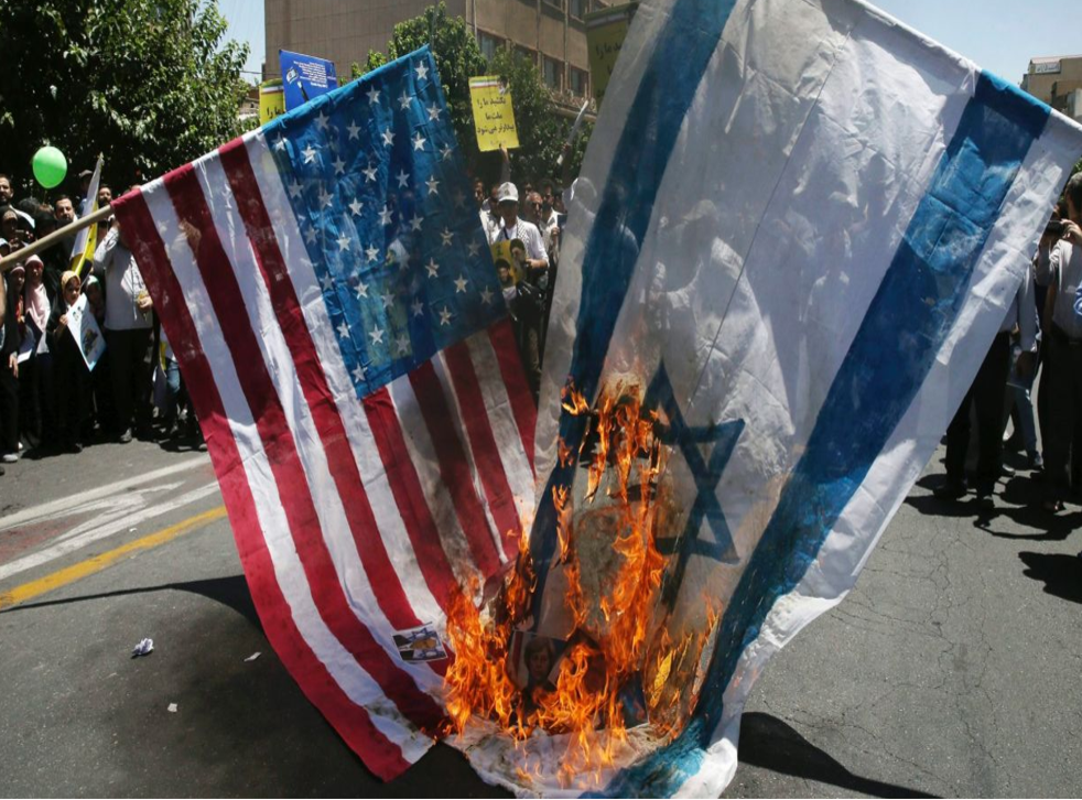 Demonstrators burn Israeli and American flags in Tehran on Al-Quds Day, an annual display of support for Palestinians against Israel and of the importance of the city of Jerusalem to Muslims, on 23 June 2017