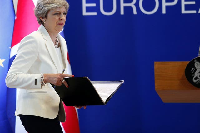 Theresa May arrives at a news conference at the EU summit in Brussels