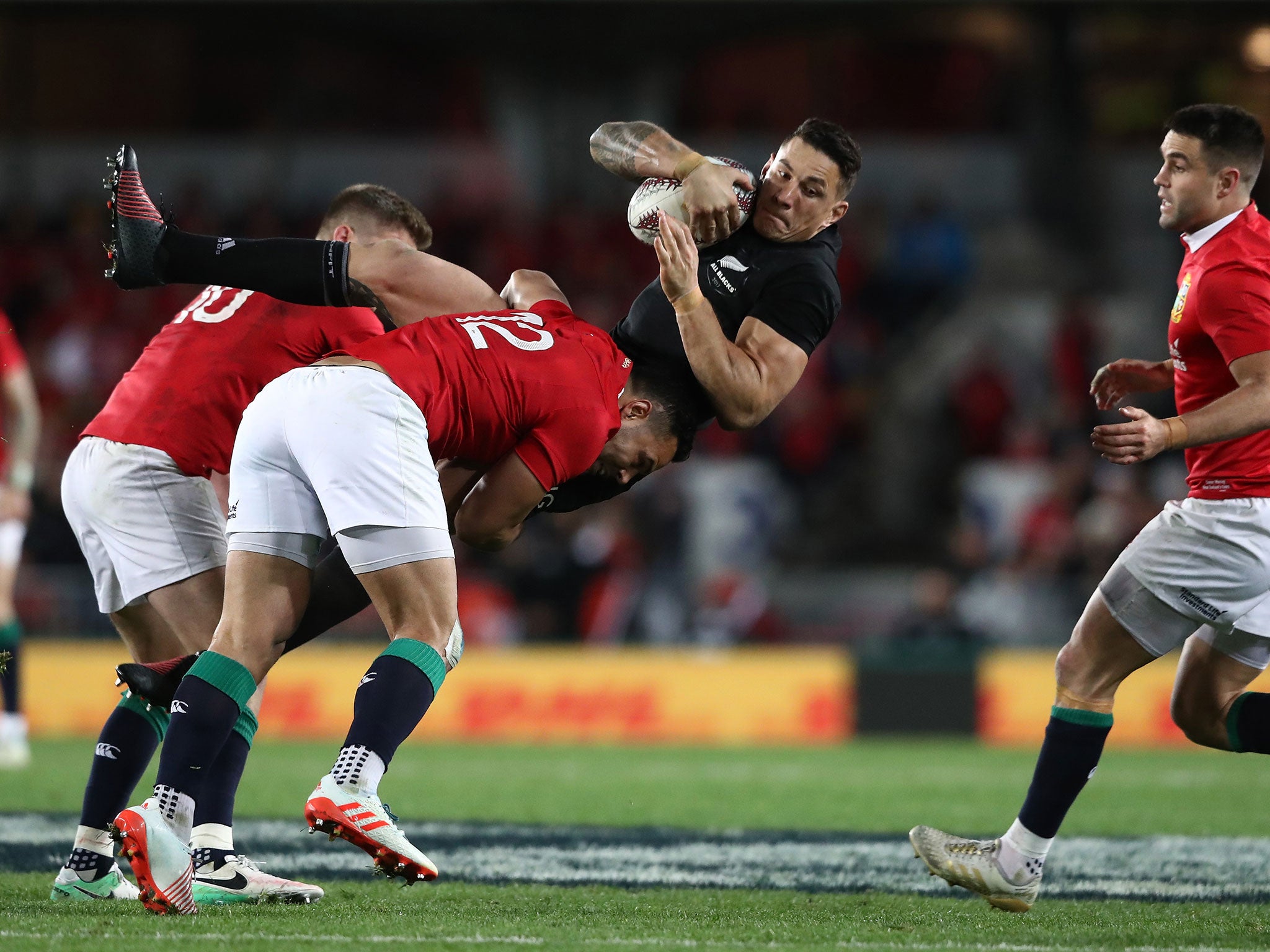 Sonny Bill Williams is tackled by Owen Farrell and Ben Te'o