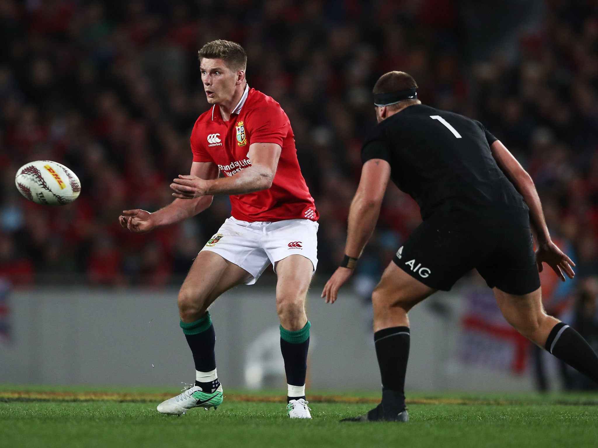 Owen Farrell looks to make the pass before being tackled