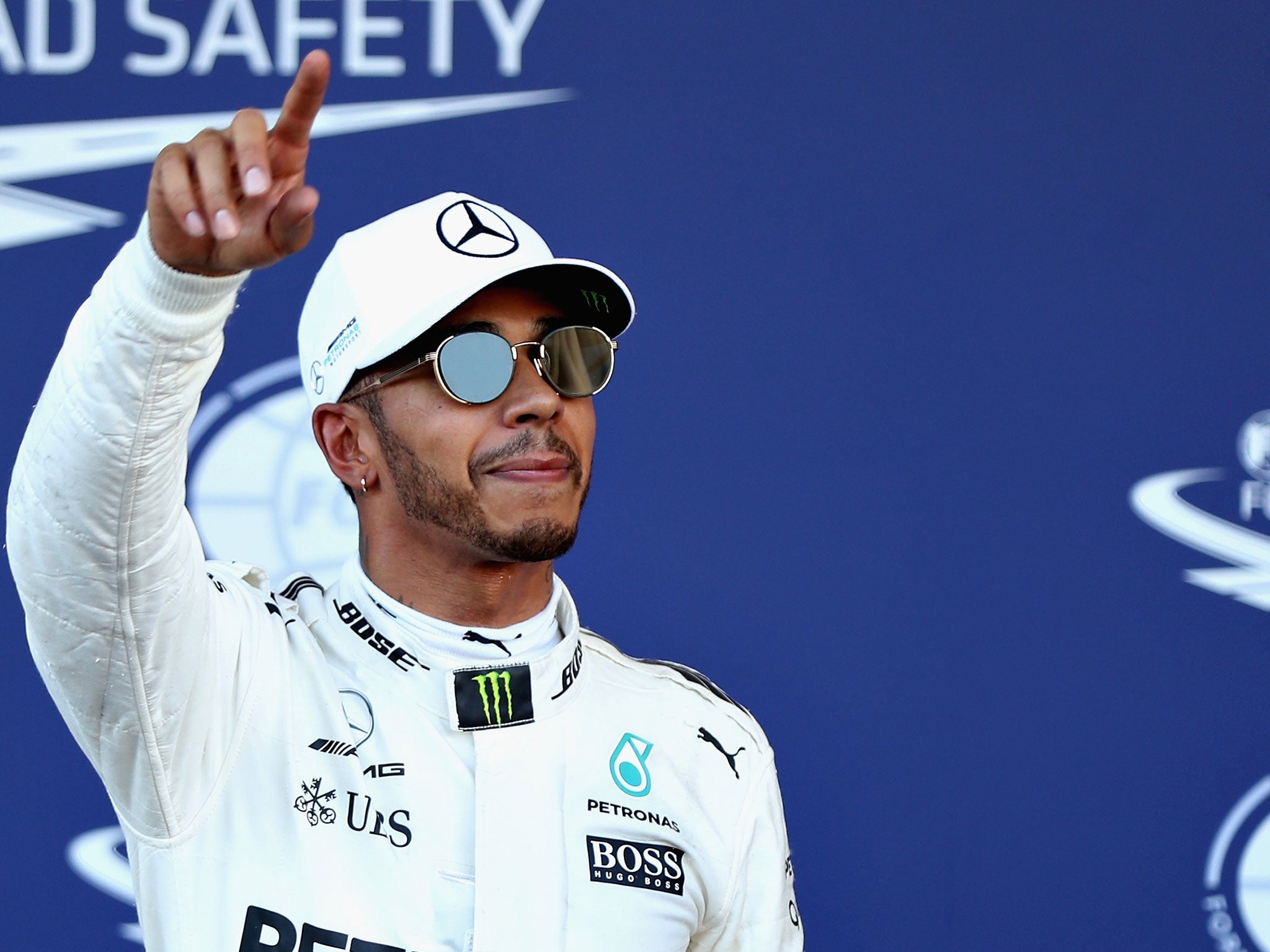 Lewis Hamilton celebrates after claiming pole