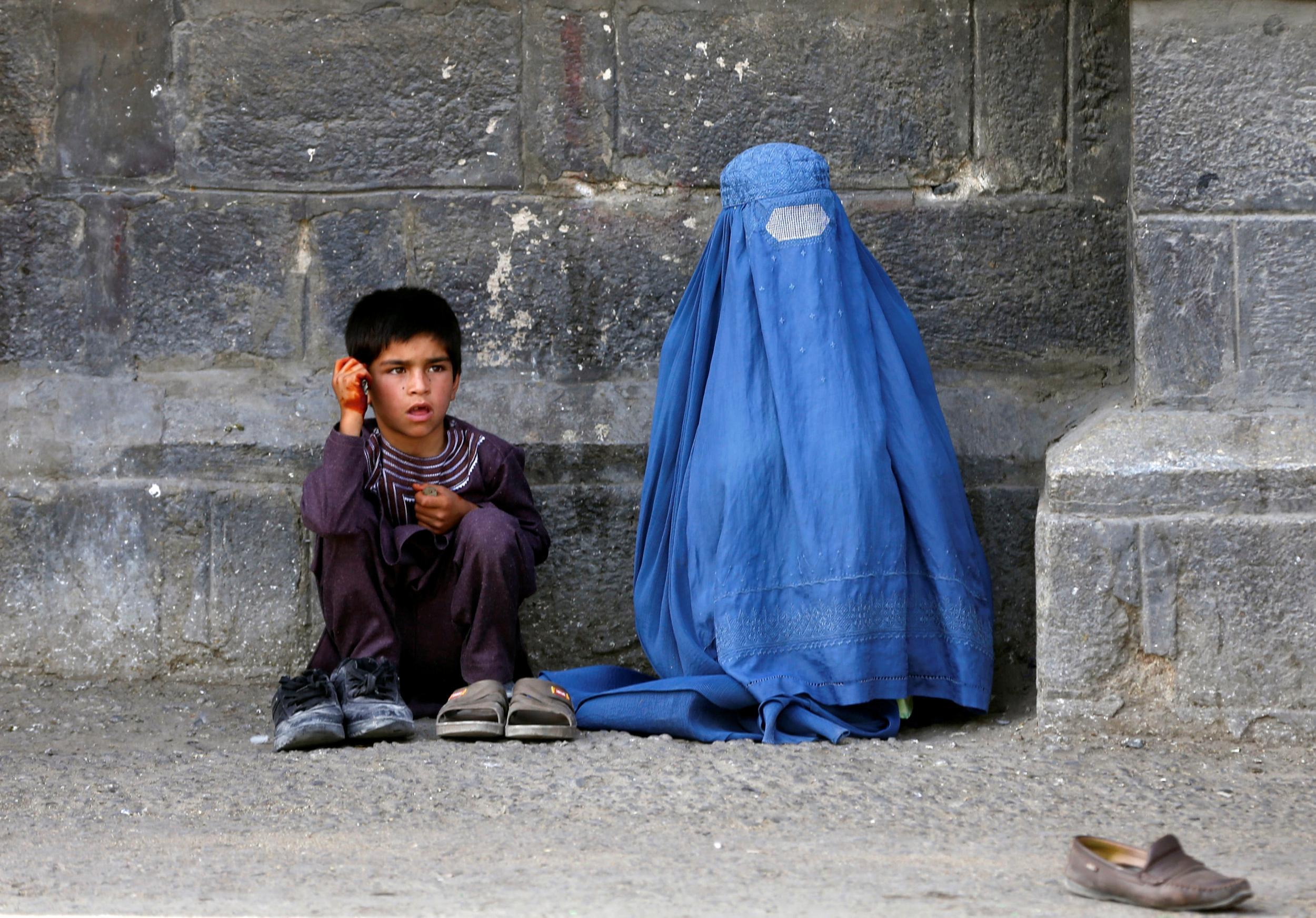 An Afghan woman and her son beg at a Kabul mosque on the first day of Eid (Reuters / Omar Sobhani)