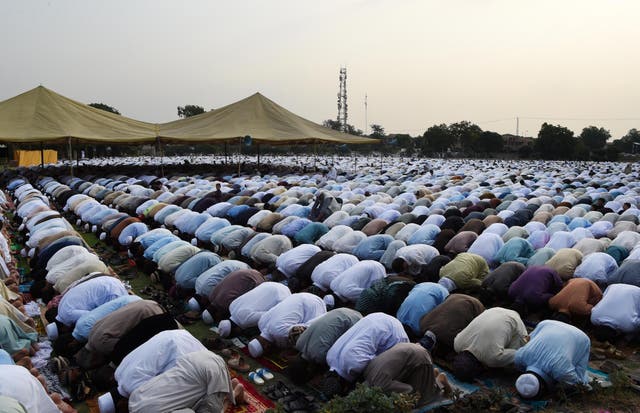 Pakistani residents offer Eid al-Fitr prayers on the outskirts of Peshawar
