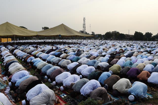 Pakistani residents offer Eid al-Fitr prayers on the outskirts of Peshawar