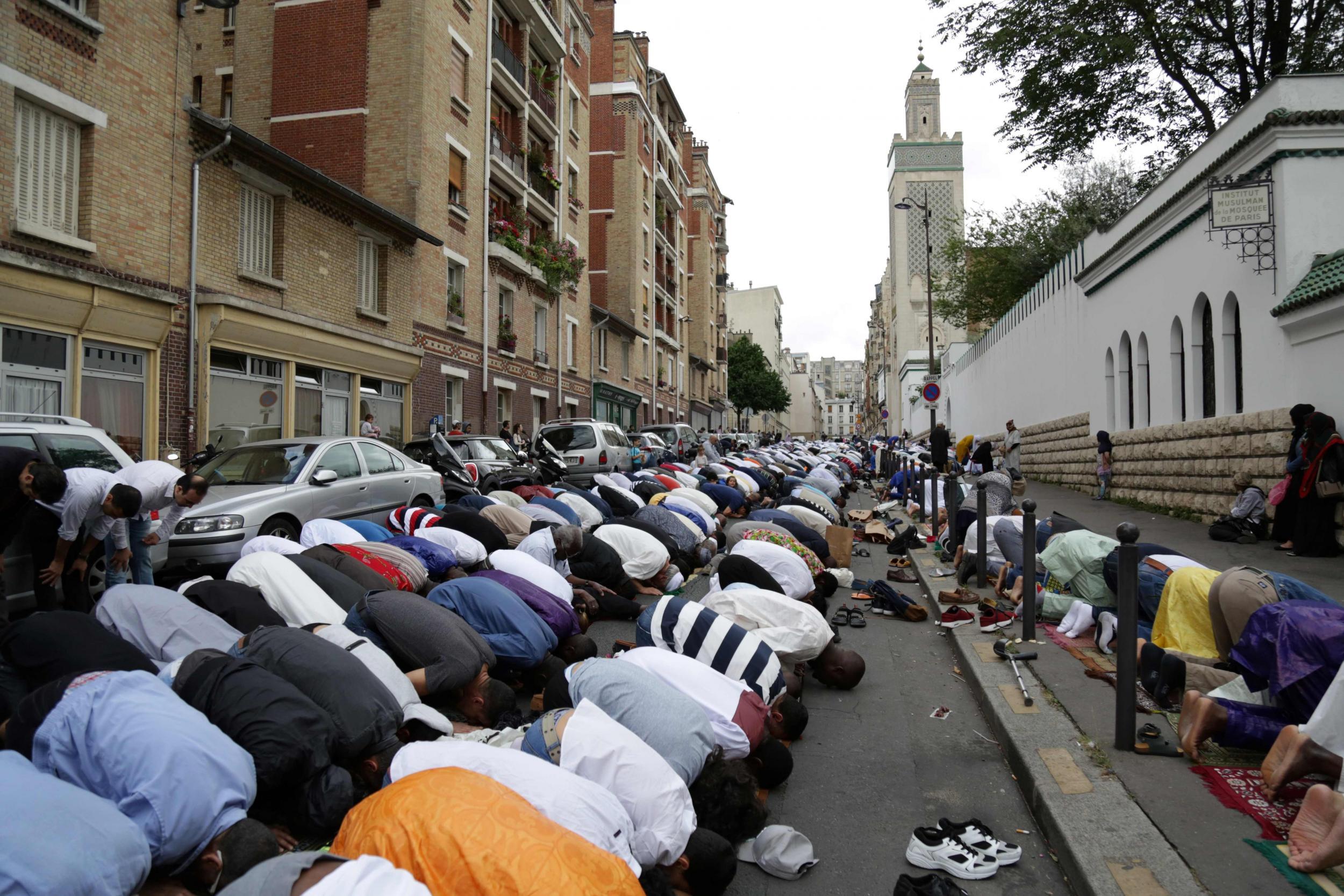 Muslims offer prayers outside the Grande Mosquee de Paris (Great Mosque of Paris)
