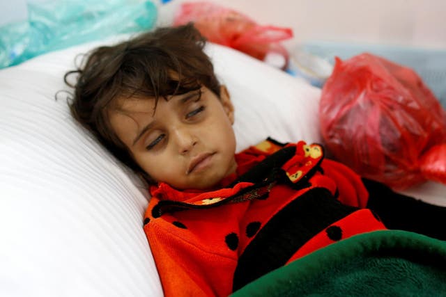 A girl infected with cholera lies on the ground at a hospital in Sanaa, Yemen