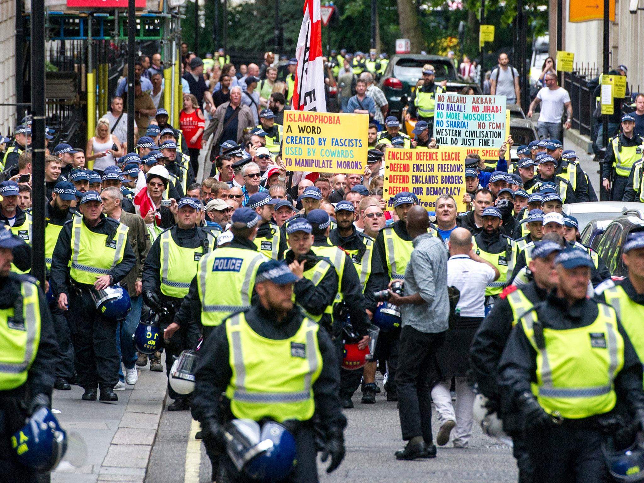 Members of the far-right anti-immigration English Defence League (EDL) march from Victoria Embankment to Charing Cross Station under heavy police guard, in Londnon