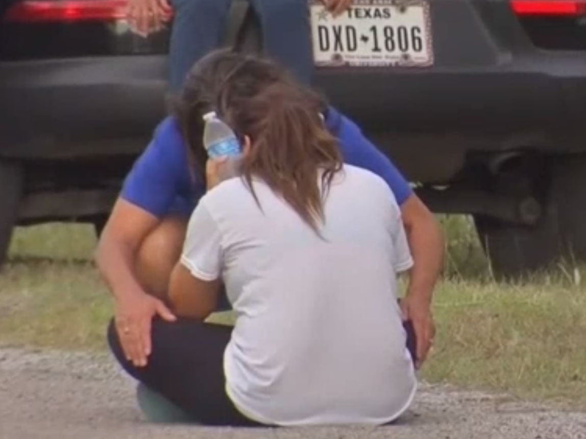 Randolph sits on the ground after discovering her children unresponsive