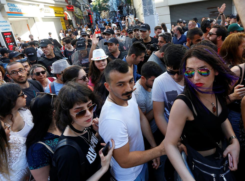 Riot police disperse LGBT rights activists as they try to gather for a pride parade, which was banned by the governorship, in central Istanbul, Turkey