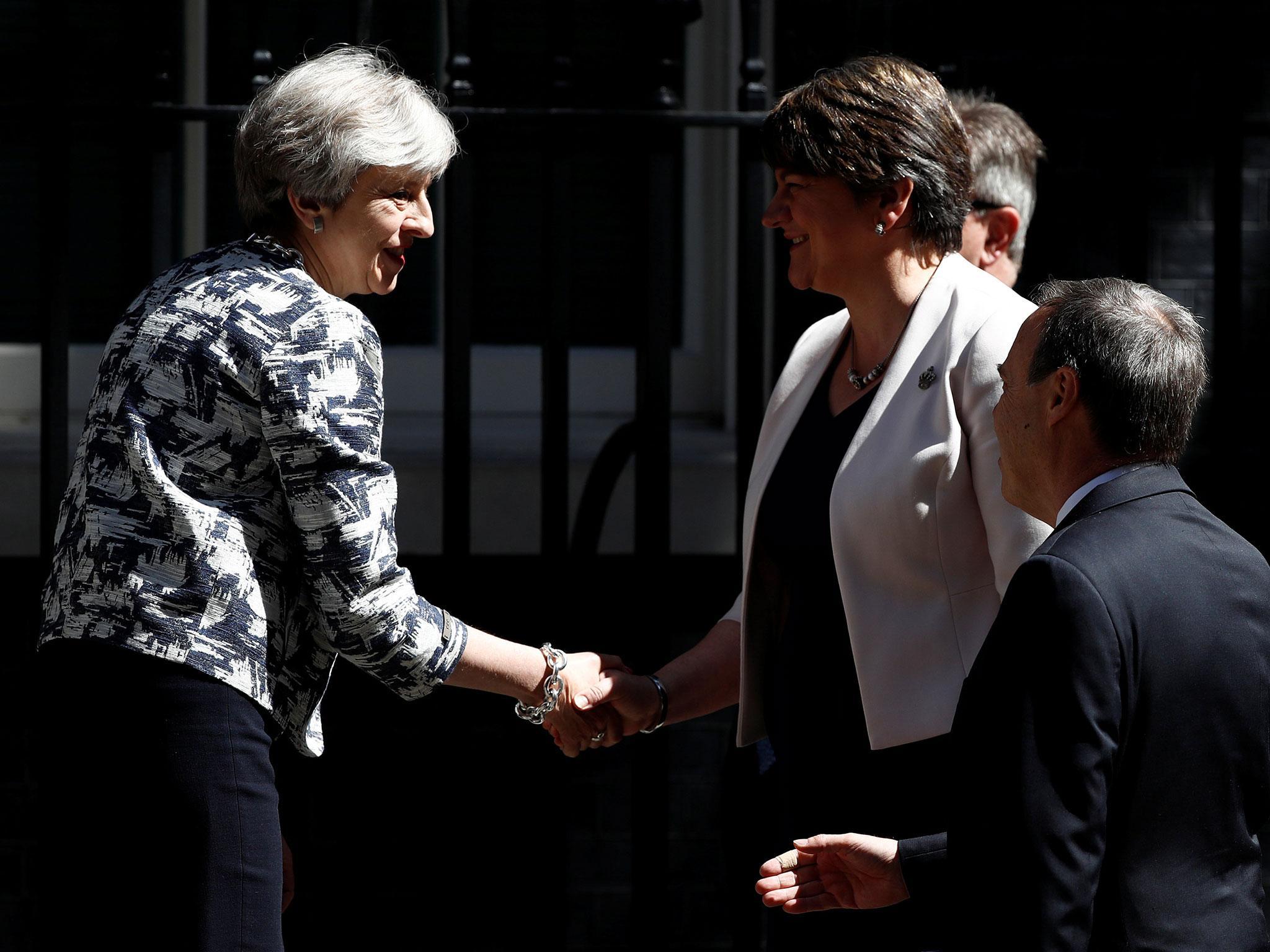 Theresa May and Arlene Foster, the DUP leader, shake hands after signing their deal in June