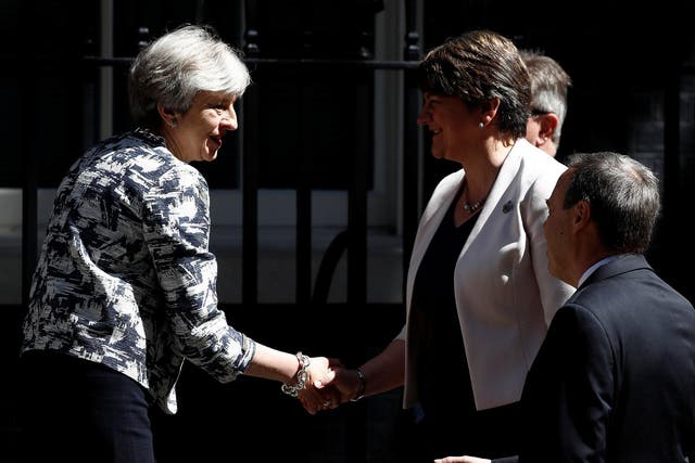 Theresa May and Arlene Foster, the DUP leader, shake hands after their deal was signed in June