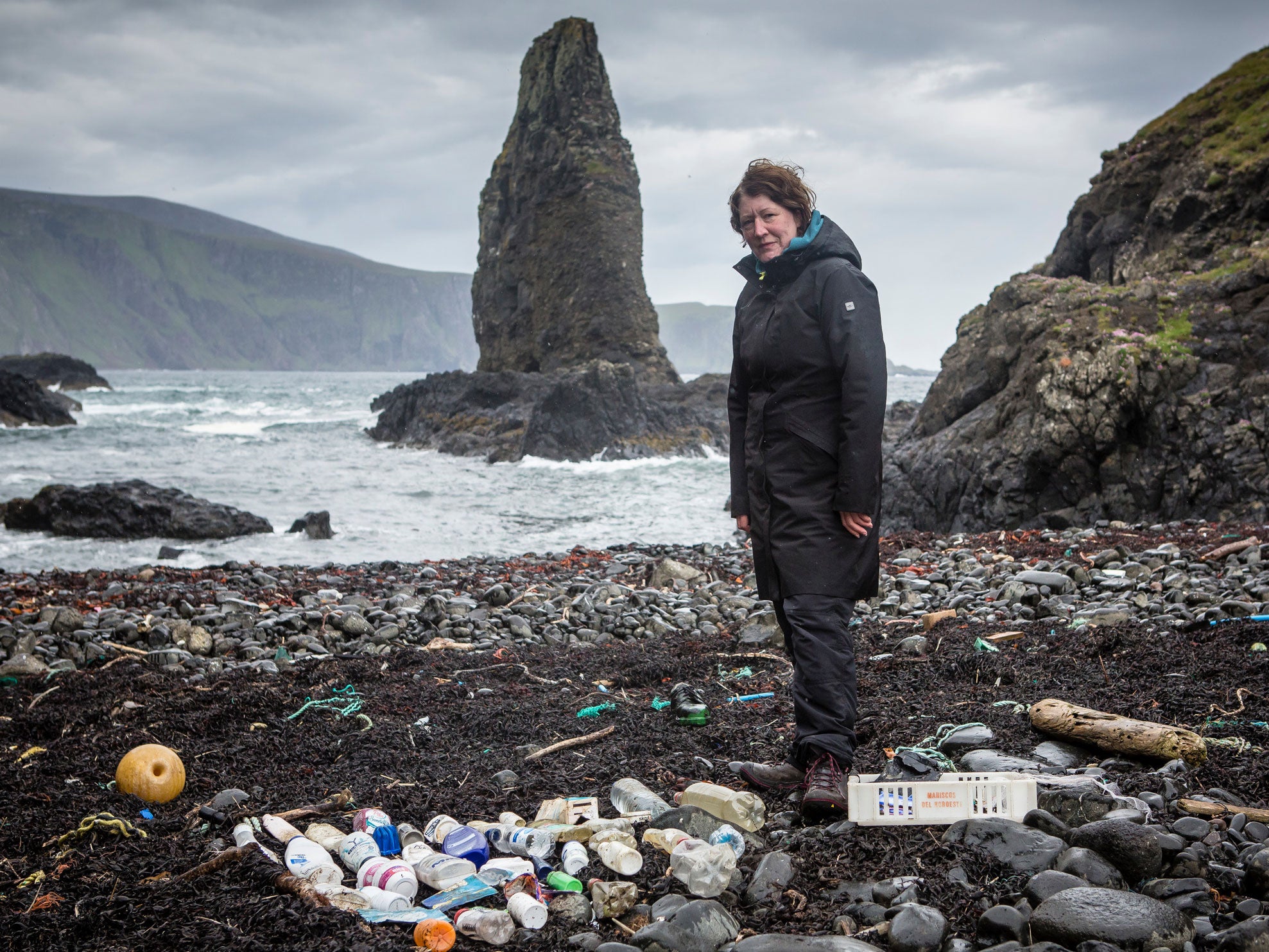 Artist Mandy Barker at a beach on Canna with a collection of some of the plastic rubbish found there