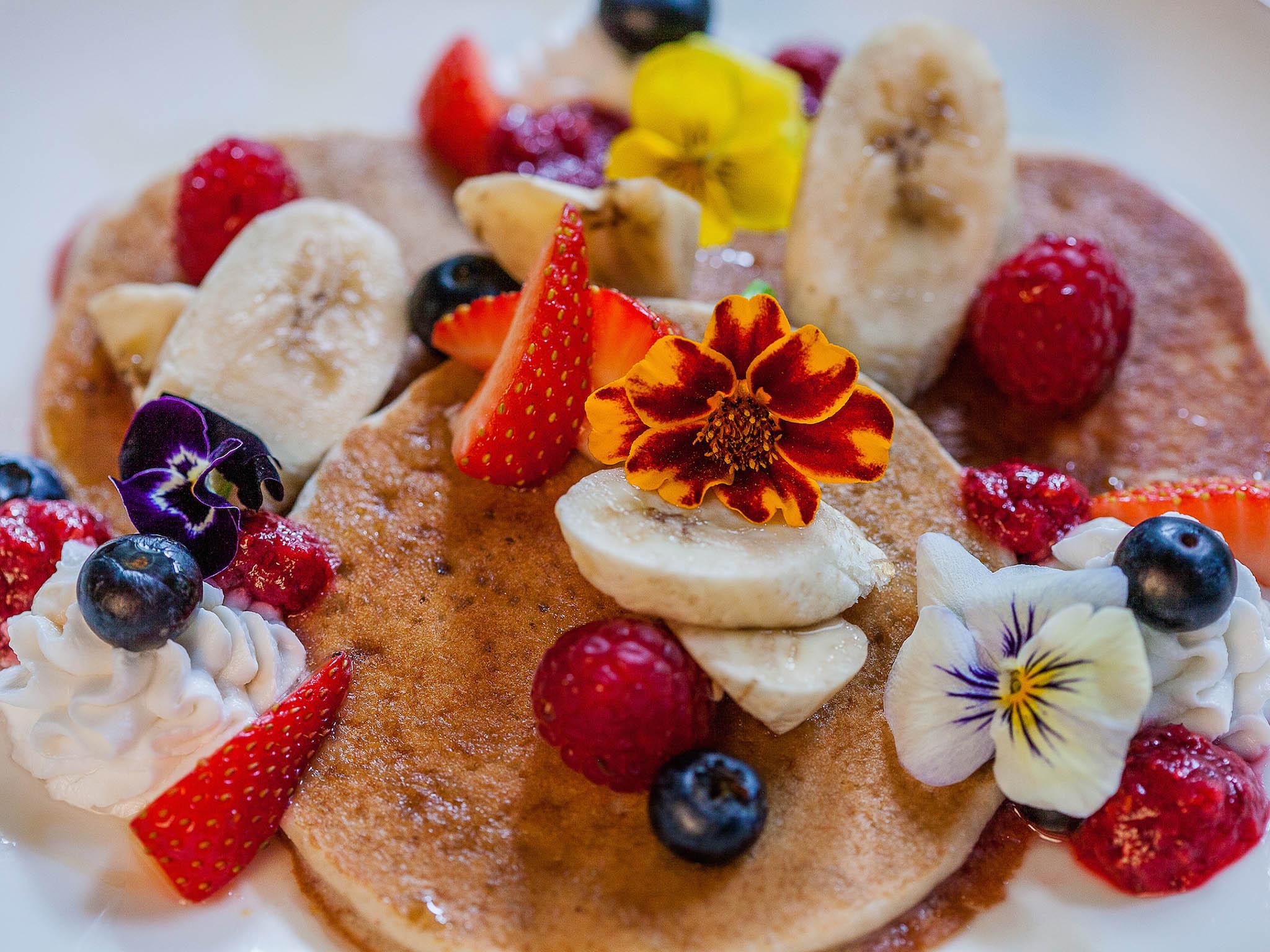 The pancakes are made with buckwheat and served with fresh berries and chai berry jam