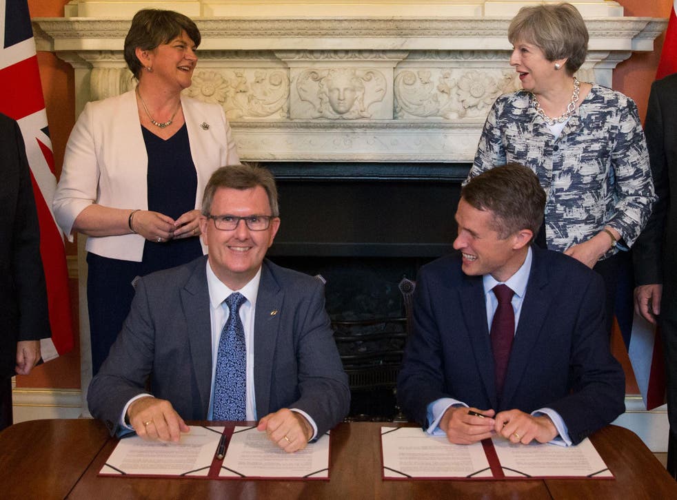 The deal was announced after Theresa May met with DUP leader Arlene Foster, DUP MP Jeffrey Donaldson (front left) and Chief Whip Gavin Williamson