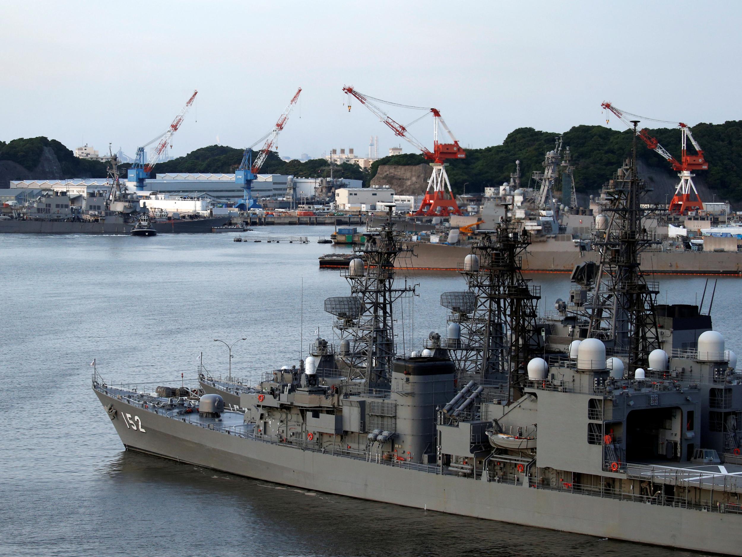 The Arleigh Burke-class guided-missile destroyer USS Fitzgerald, damaged by colliding with a Philippine-flagged merchant vessel, is towed into the US naval base in Yokosuka, south of Tokyo