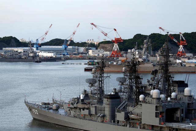 The Arleigh Burke-class guided-missile destroyer USS Fitzgerald, damaged by colliding with a Philippine-flagged merchant vessel, is towed into the US naval base in Yokosuka, south of Tokyo
