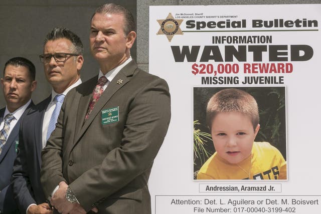 Los Angeles County Sheriff's Department Homicide Bureau Captain Christopher Bergner, centre, stands by a poster of Aramazd Andressian Jr, a five-year-old boy who has been missing for several weeks from South Pasadena