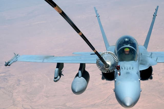 A US Marine Corps F-18 Super Hornet receives fuel from a 908th Expeditionary Air Refueling Squadron KC-10 Extender on 31 May 2017, over an undisclosed location above Syrian or Iraqi airspace