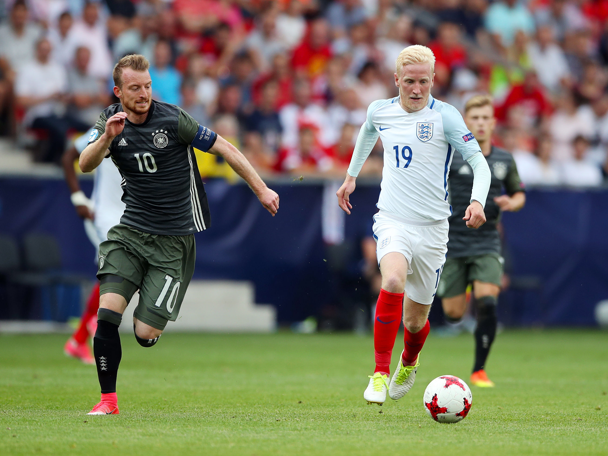 England's Will Hughes darts past Germany's Maximilian Arnold