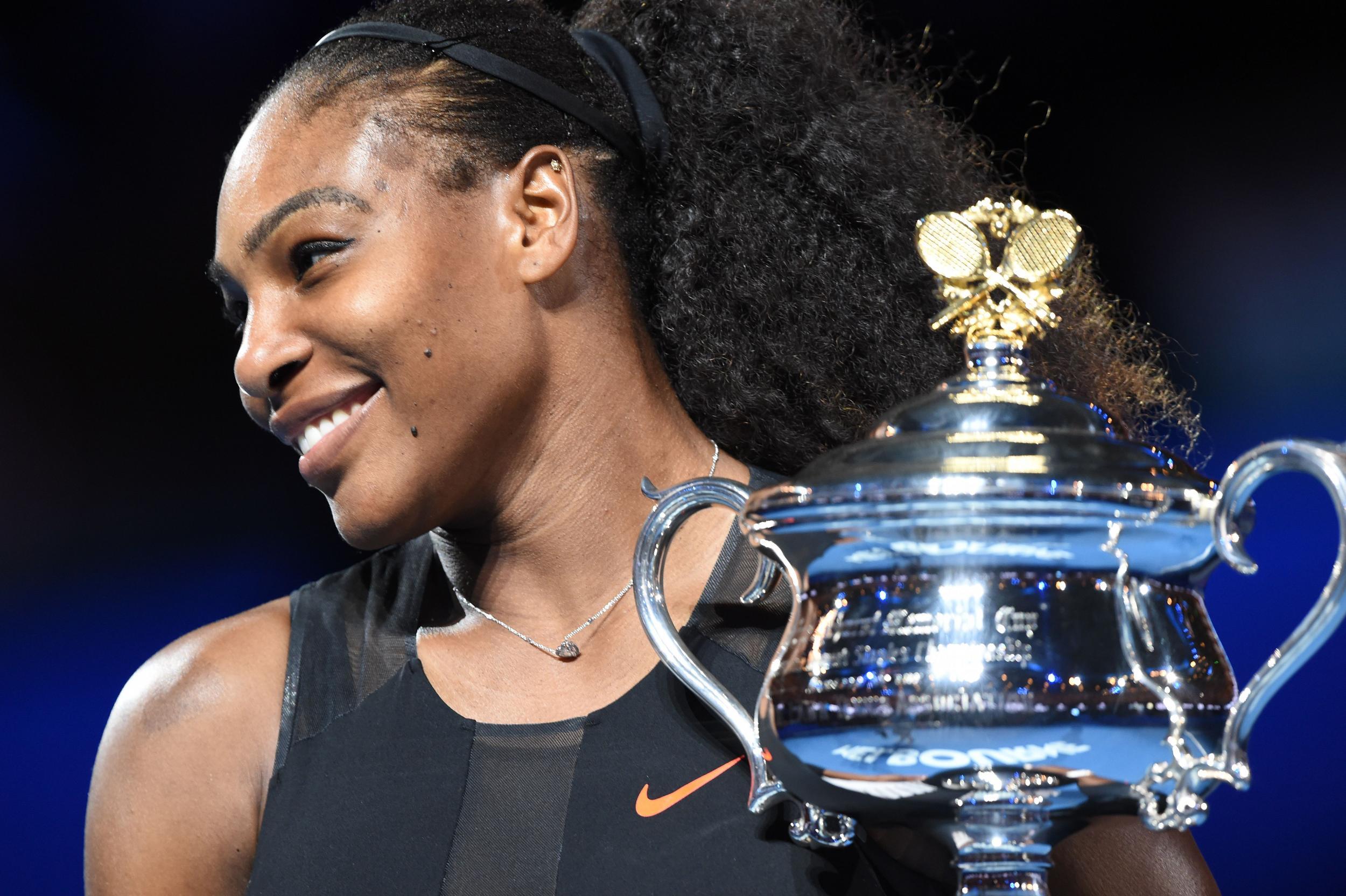 Serena Williams of the US holds up the trophy following her victory over Venus Williams of the US in the women's singles final