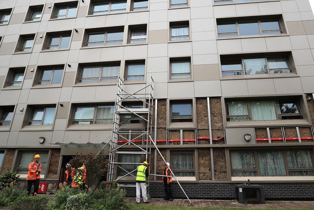 Workers remove cladding from Hornchurch Court, a block in Hulme, Manchester