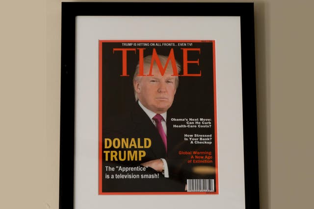 Framed portrait of President Donald Trump on the cover of a Time magazine and other magazine covers framed and hanging from a wall at the Trump National Doral Miami Golf Shop