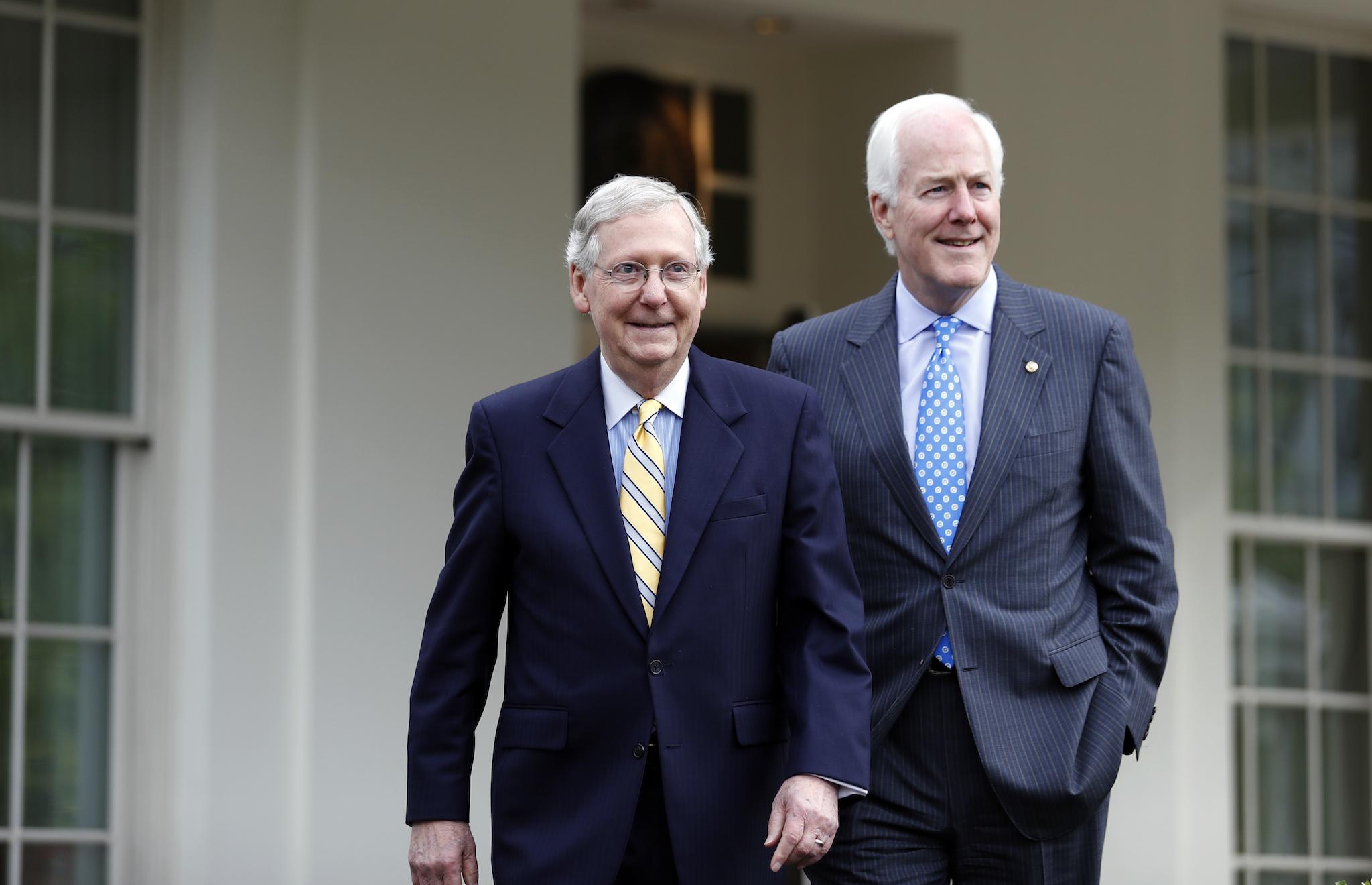 Senate Majority Leader Mitch McConnell and Senate Majority Whip John Cornyn walk to speak with the media after they and other Senate Republicans had a meeting with President Donald Trump at the White House