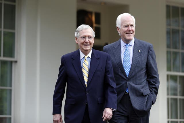 Senate Majority Leader Mitch McConnell and Senate Majority Whip John Cornyn walk to speak with the media after they and other Senate Republicans had a meeting with President Donald Trump at the White House