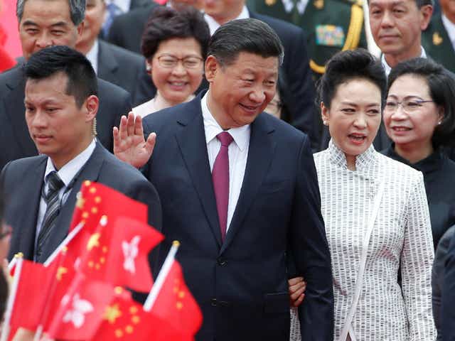Chinese President Xi Jinping and his wife Peng Liyuan arrive in Hong Kong
